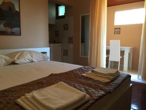 a bedroom with a bed with towels on it at Apartments and Rooms Sinka in Biograd na Moru