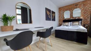 Łóżko lub łóżka w pokoju w obiekcie Apartamenty KB Toruń