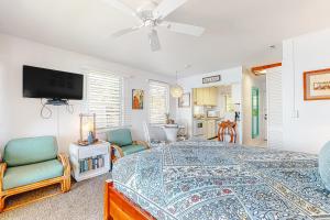 a bedroom with a bed and a flat screen tv at Kapa'a Sands 07 in Kapaa