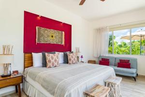 a bedroom with a large bed and a red wall at Villa Calma, Chic & Mexican Villa, a True Oasis Pool, Security in Tulum +131 photos