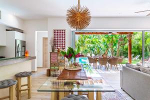 a kitchen and living room with a table and chairs at Villa Calma, Chic & Mexican Villa, a True Oasis Pool, Security in Tulum