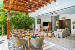 a living room with a table and chairs at Villa Calma, Chic & Mexican Villa, a True Oasis Pool, Security in Tulum