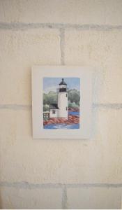 a picture of a lighthouse on a brick wall at Isla de Tabarca: Casa Trinacria in Tabarca