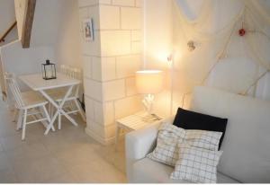 a living room with a white couch and a table at Isla de Tabarca: Casa Trinacria in Tabarca