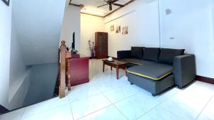 a living room with a couch and a table at Haus 19 in Puli