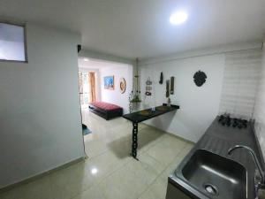 a kitchen with a sink and a table in a room at Sunset View, Taganga in Taganga