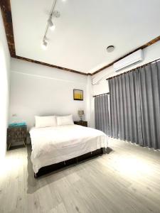 a bedroom with a bed and a large window at Haus 19 in Puli