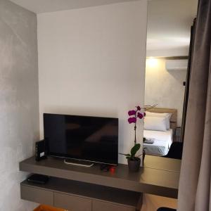 a flat screen tv sitting on a table in a room at KaLuMa in Belgrade