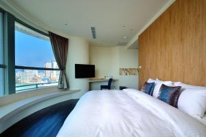 Rúm í herbergi á Merryday Hotel Banqiao