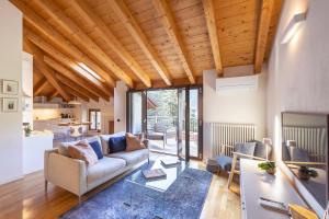 a living room with a couch and a table at Casa Agatha Lenno- luxury air conditioned village home by Italian Apartments in Lenno