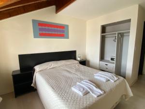 Postel nebo postele na pokoji v ubytování Hotel Sun Bariloche