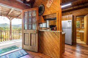 a kitchen with a refrigerator and a door to a balcony at R&R Retreat in Sunshine