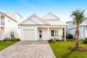 a white house with a palm tree in the yard at A Wave From It All in Rosemary Beach