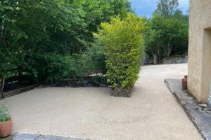 a bush sitting in the middle of a driveway at Villa du Cerney - Lake des Settons in Moux-en-Morvan