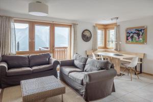 a living room with a couch and a table at Camelot 3 in Bettmeralp