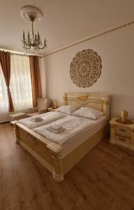 a bedroom with a large bed and a chandelier at Hotel Union in Louny