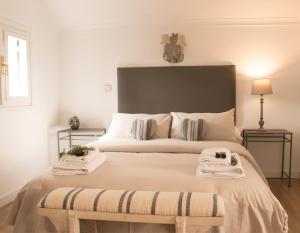 a bedroom with a large bed with towels on it at Cabañas Navacerrada in Navacerrada