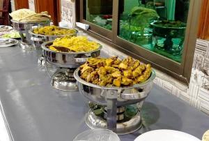 a buffet with three bowls of food on a table at C4 Mirpur City AJK Overseas Pakistanis Villa - Full Private House & Car Parking in New Mīrpur