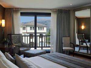 a hotel room with a bed and a balcony at Hotel Du Lac Congress Center & Spa in Ioannina +50 photos