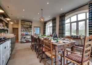 a kitchen with a large wooden table and chairs at North Farm in Walworth
