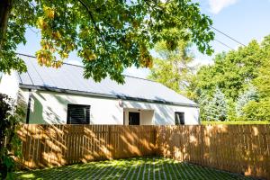 een witte schuur achter een houten hek bij Spokojnia in Lubrza