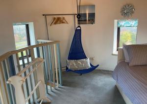 a room with a blue hammock hanging from the wall at The Old Windmill in Kirkbymoorside