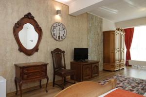 a living room with a clock and a mirror at Стаи за гости RADEA in Devin +27 photos