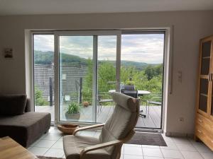 a living room with a view of a living room at SauerlandBlick in Altena