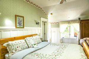 a bedroom with a bed with a wooden head board at The Old St Angela Inn in Pacific Grove