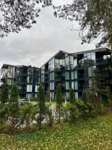 an apartment building with a lot of windows at Naujai įrengti pušyno apartamentai - bekontaktis įėjimas in Birštonas