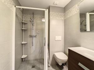 a bathroom with a shower and a toilet and a sink at Appartement lumineux 3 chambres, parking privé, au pied des pistes - FR-1-416-87 in La Toussuire