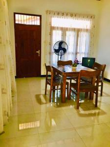 a dining room table and chairs in a room at st anns holiday home negombo in Negombo