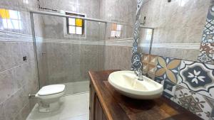 a bathroom with a sink and a toilet at Pouso Flor da serra in Tiradentes +13 photos