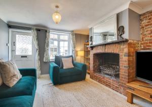 a living room with a couch and a fireplace at Pebble Beach Cottage in Rottingdean