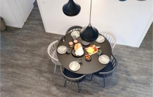 a table with a plate of food on it at Beach Front Home In Lembruch-dmmer See With Wifi in Lembruch