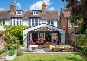 an extension to a house with a patio at Red Doors in Canterbury