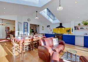 a kitchen and dining room with a table and chairs at Red Doors in Canterbury