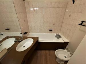 łazienka z umywalką, wanną i toaletą w obiekcie Studio Les Menuires, 1 pièce, 4 personnes - FR-1-452-187 w Les Menuires