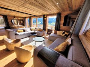 a living room with a couch and chairs in a house at Chalet Les Gets, 5 pièces, 14 personnes - FR-1-598-41 in Les Gets