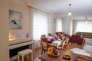 a living room with a table and a piano at Villa Cozy in Marmaris