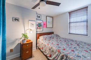 a bedroom with a bed and a dresser and a window at Bedroom in thoughtfully decorated East Passyunk home (South Philadelphia) in Philadelphia
