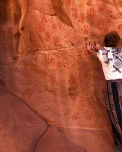 a person is climbing on a rock wall at Bedouin bunch camp in Wadi Rum