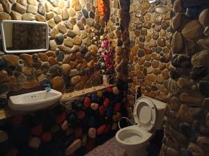 ein Steinbad mit einem WC und einem Waschbecken in der Unterkunft sunny Tayai hostel pai in Pai