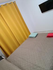 a bed in a room with yellow and blue sheets at Bucovina Cazare in Câmpulung Moldovenesc