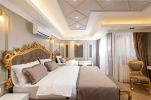 a bedroom with a large bed with a gold frame at Azalea Mansion Oldcity in Istanbul