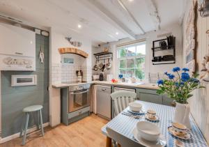 a kitchen with a table and a counter top at Little Rosa in Wells next the Sea
