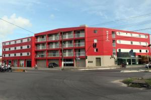 a red building on the corner of a street at Hotel Aracaju Express in Aracaju