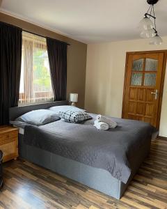 a bedroom with a bed with two towels on it at Klimkowa Chata in Zakopane