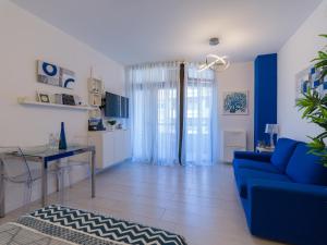 ein Wohnzimmer mit einem blauen Sofa und einem Tisch in der Unterkunft Casa Blanca Las Canteras in Las Palmas de Gran Canaria