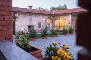 cortile con piante in vaso di fronte a un edificio di B&b Il Cortile a Biella